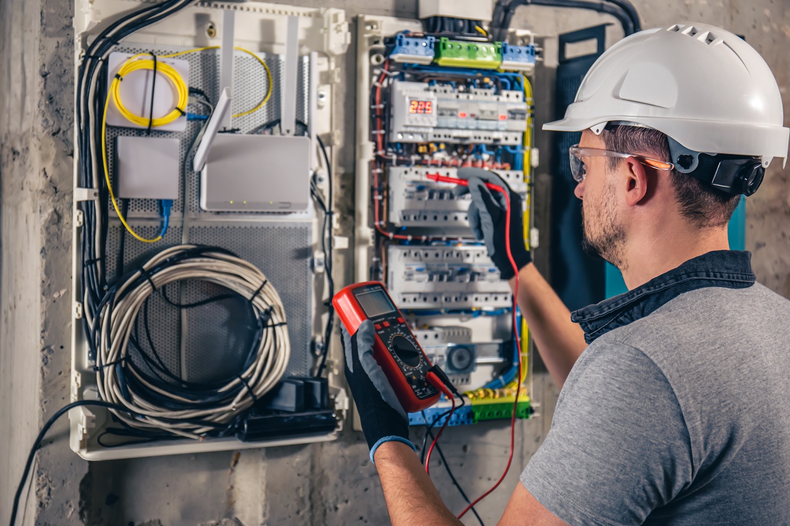 Electrical technician working on switchboard